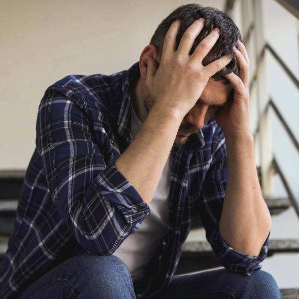 Man holding head in a both hands