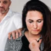 Battered woman with a man grabbing her shoulder
