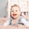 Smiling baby girl on carpet