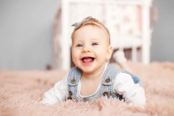 Smiling baby girl on carpet