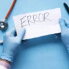 The word Error on a paper held by medical gloved hands