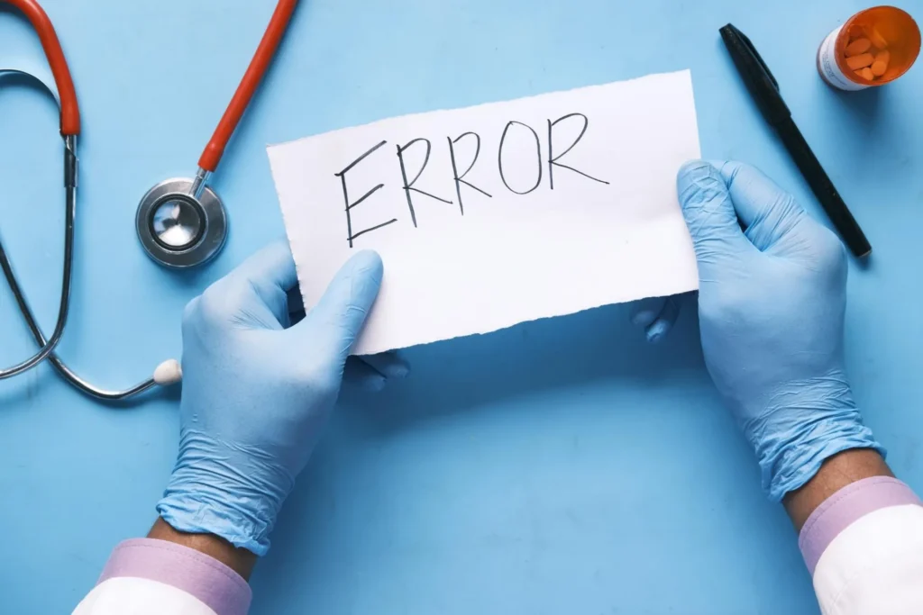 The word Error on a paper held by medical gloved hands