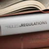 Rules and regulation books stacked on a table