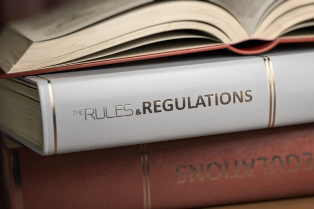 Rules and regulation books stacked on a table