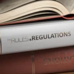 Rules and regulation books stacked on a table