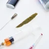 Several substances on a table: weed, syringes, lighters, and more
