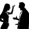 Silhouettes of man and woman couple arguing