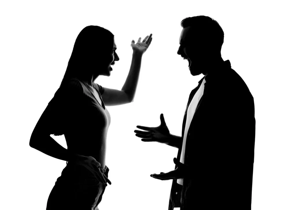 Silhouettes of man and woman couple arguing